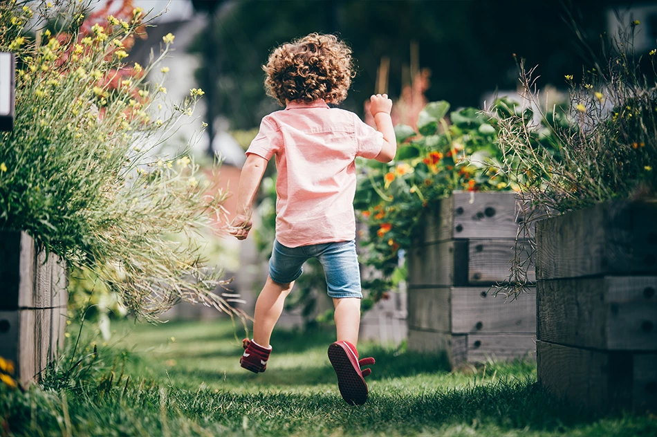 Child running through garden