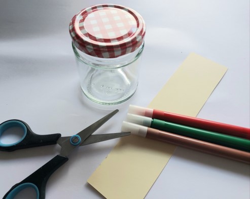 Photo of a jar, coloured pens and scissors