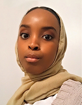 Profile headshot of young woman looking straight at the camera