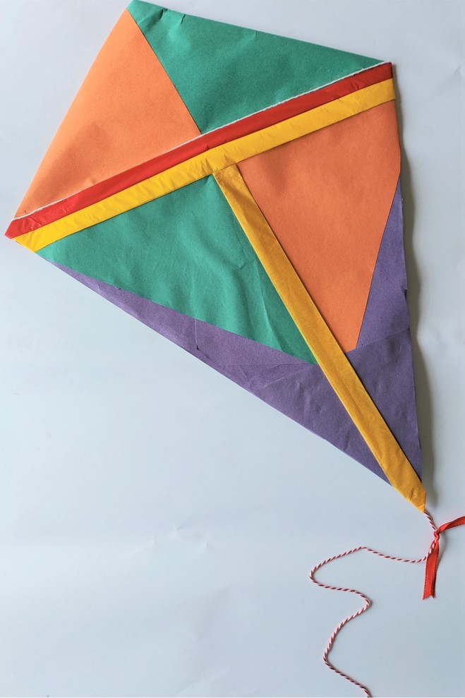 Photo of a kite made from green, orange, yellow, purple and red paper