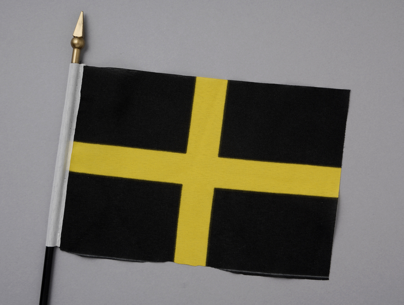 A flag with a yellow cross on a black background.