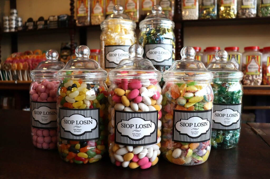 Six sweets jars on a counter at the St Fagans sweet shop