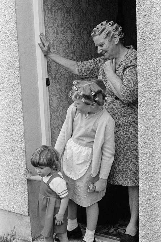 Family at their front door. Ammanford, Wales