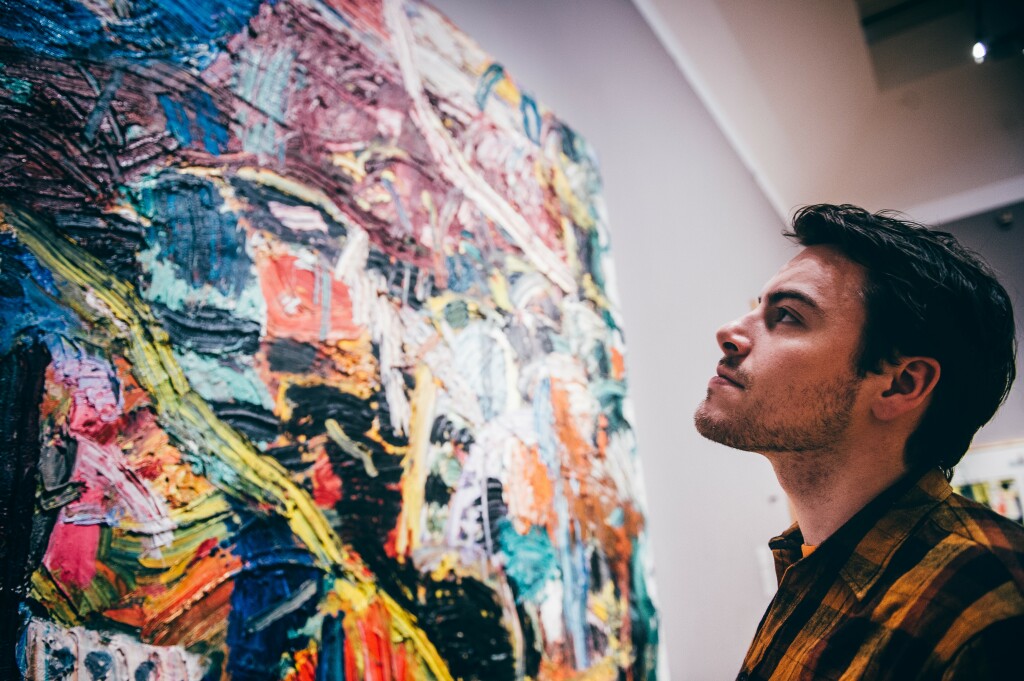 A young man admiring a piece of modern artwork