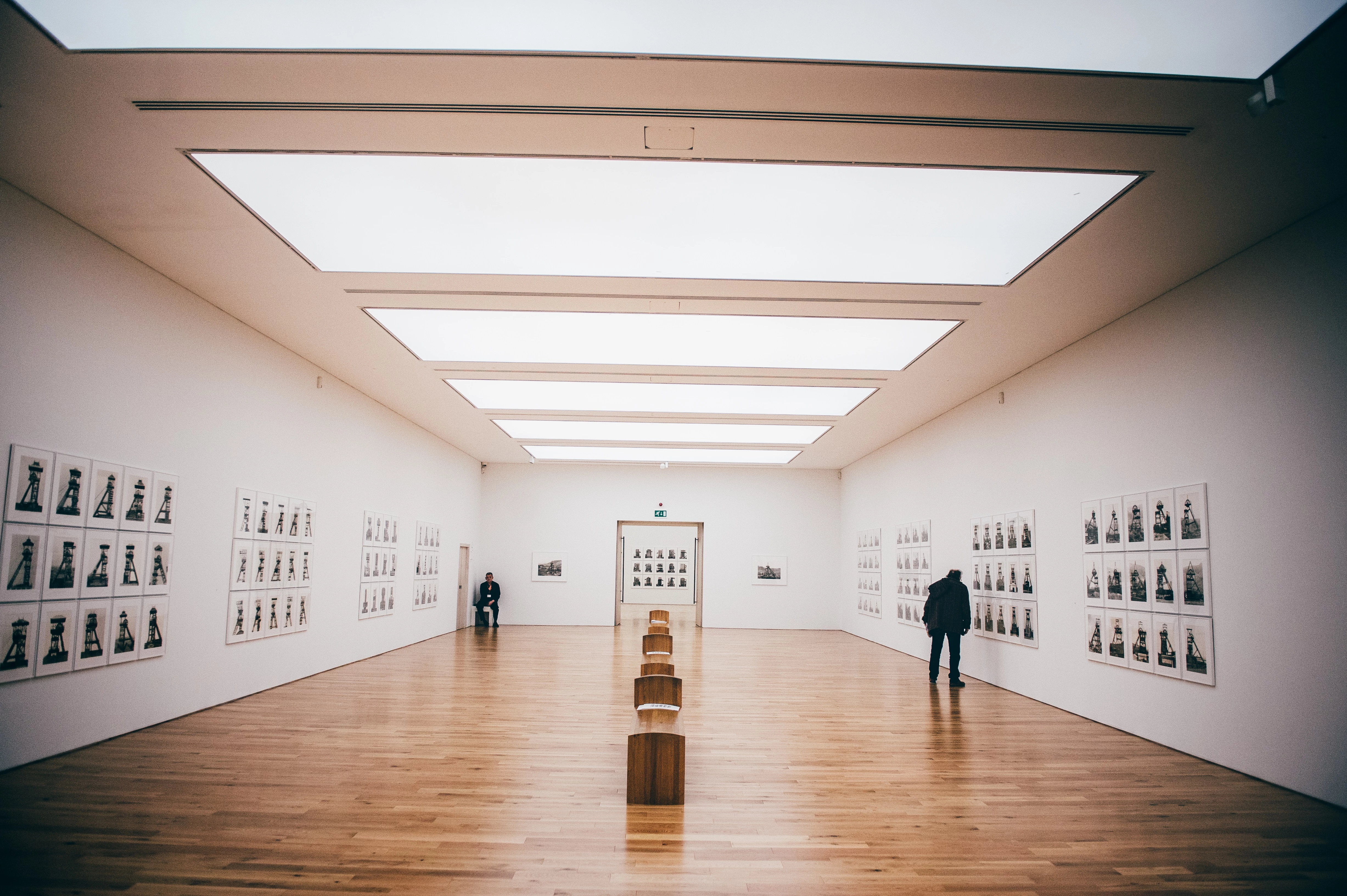 People in a gallery looking at photographs