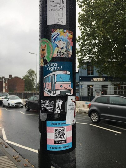 Photograph of differently shaped stickers on a lamppost 