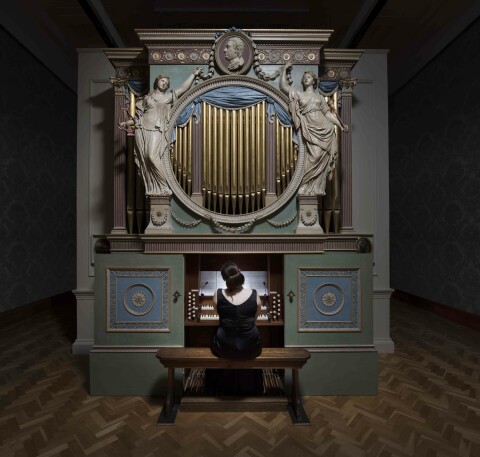 Photograph of a woman playing an organ