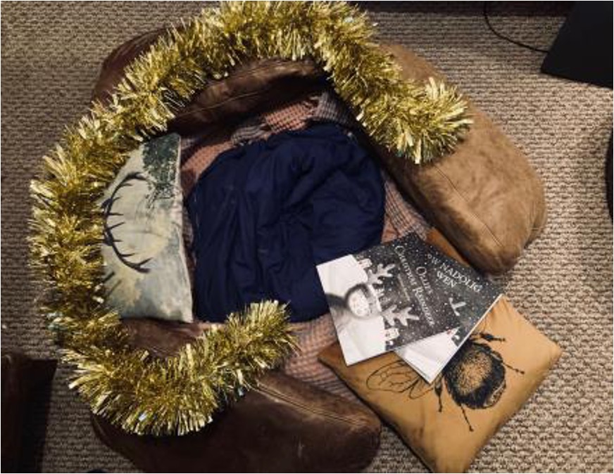 Photo of a den made from blankets, cushions and tinsel