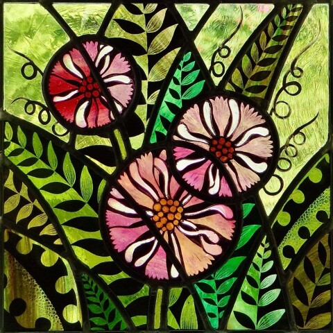 stained glass image of three flowers and leaves