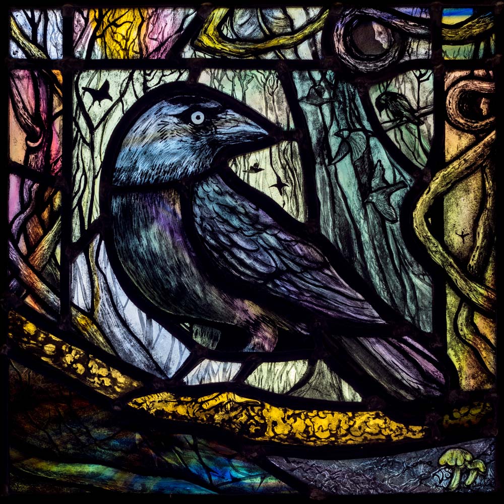 a stained glass picture of a black bird