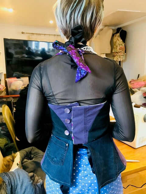 Photograph of woman trying on waistcoat