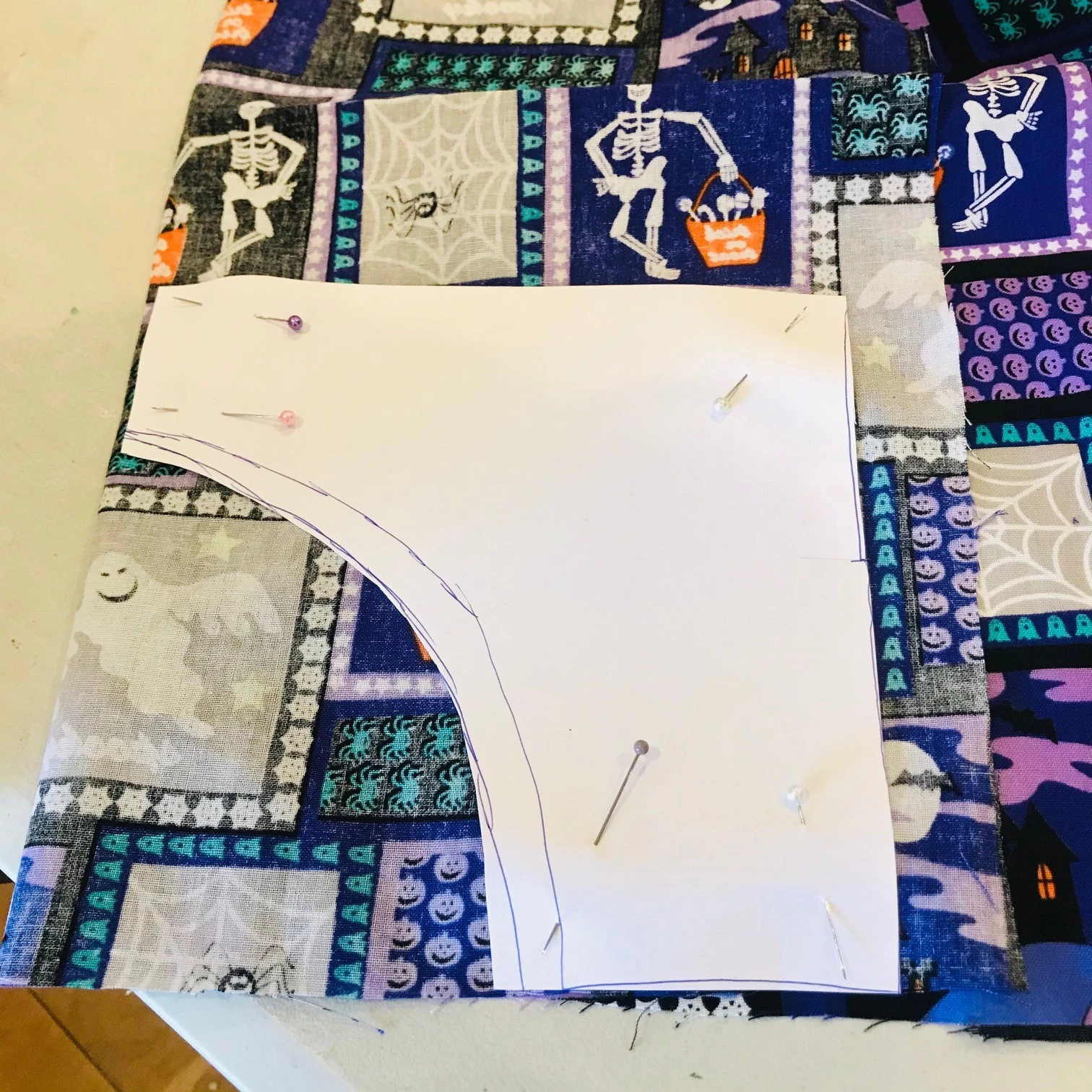 Photograph of waistcoat design outline on patterned fabric
