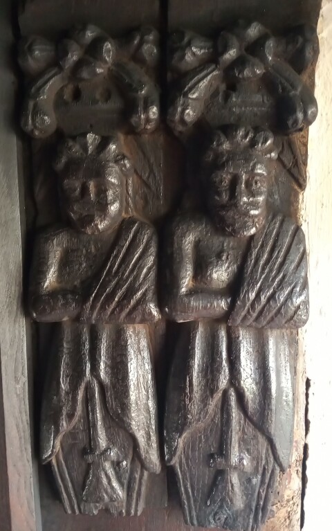 Carved figures inside the door at Kennixton, St. Fagans Museum
