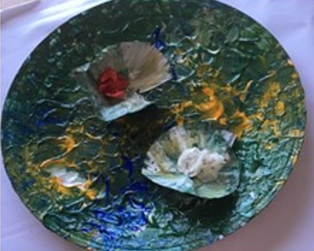 Child's painting of waterlilies made using a paper plate and cupcake cases