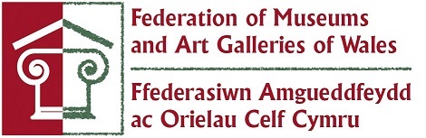 Here's the Federation of Museums and Art Galleries of Wales logo,the writing is red on a white background, there's also the outline of a heritage building on the left hand side