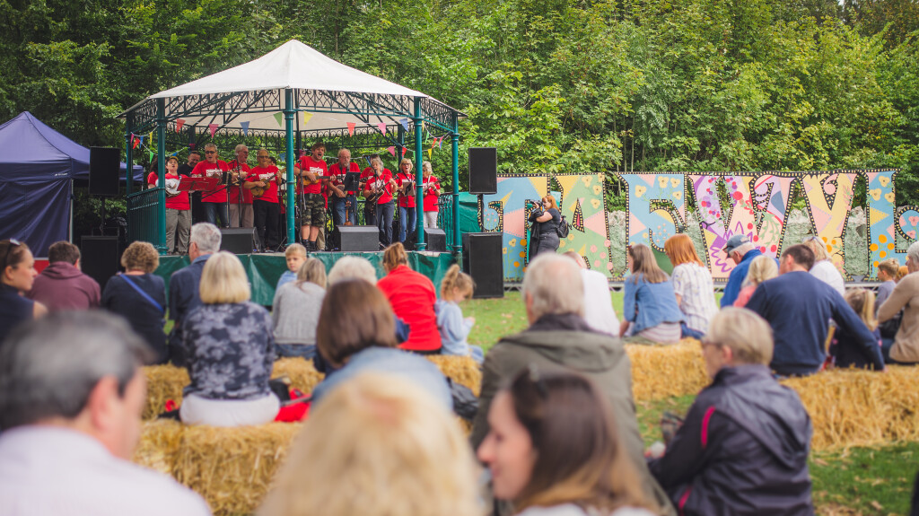 A bandstand with a ukulele band performing to an audience
