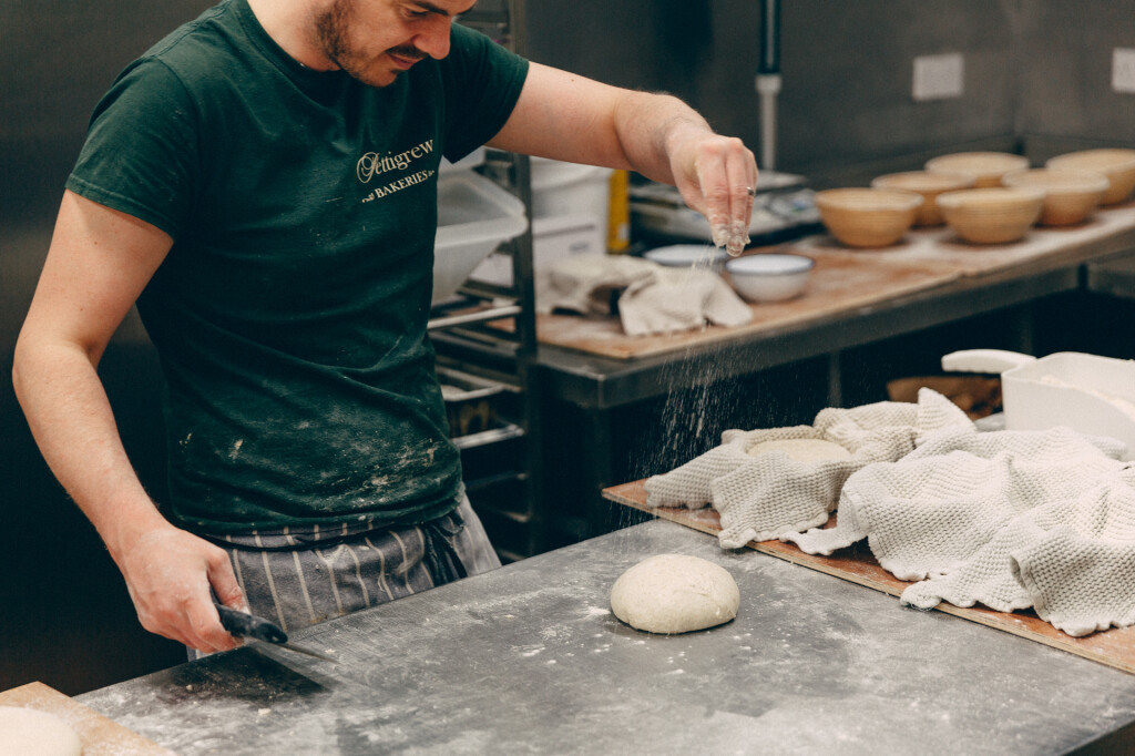 Man preparing a piece of bread dough 