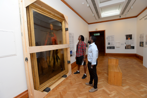 Two young people looking at the portrait of Thomas Picton