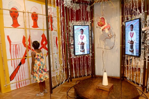 A little girl in amongst an installation made of twisted paper