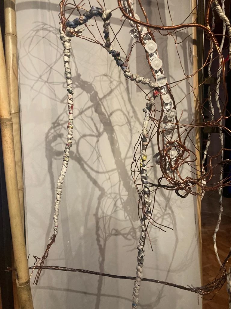 Copper and paper twisted around each other, in the process of the making of an installation