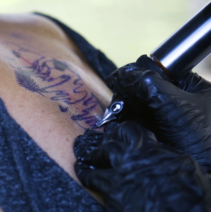 A still from Gesiye's film, showing a person in the process of being tattooed