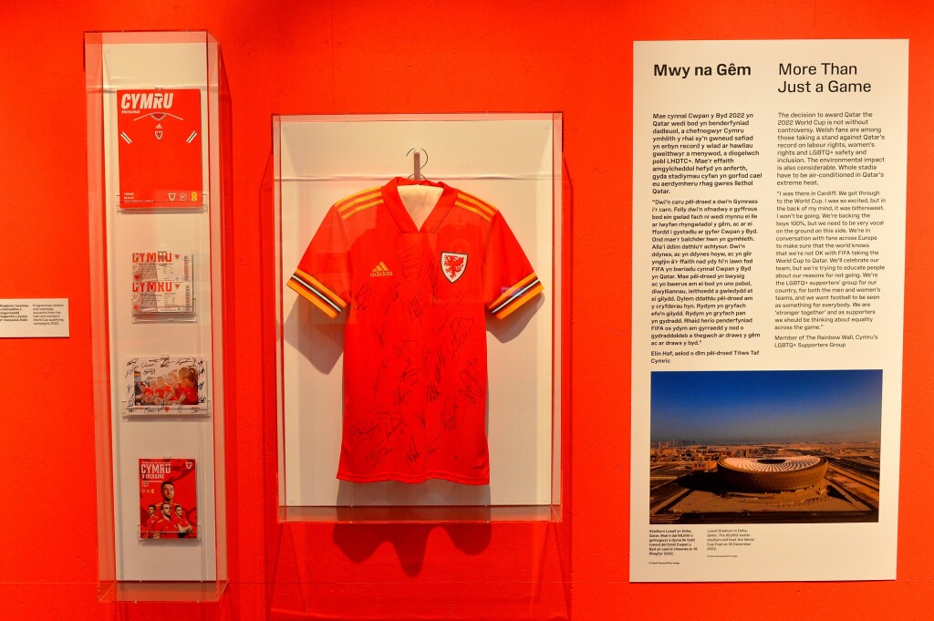 A signed Cymru football shirt next to a display of tickets and programmes 