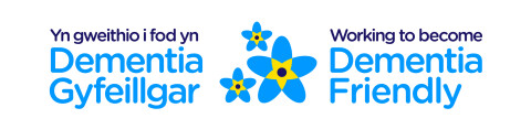 A logo made up of a blue and yellow flower, with the words Working to become Dementia Friendly to the right.