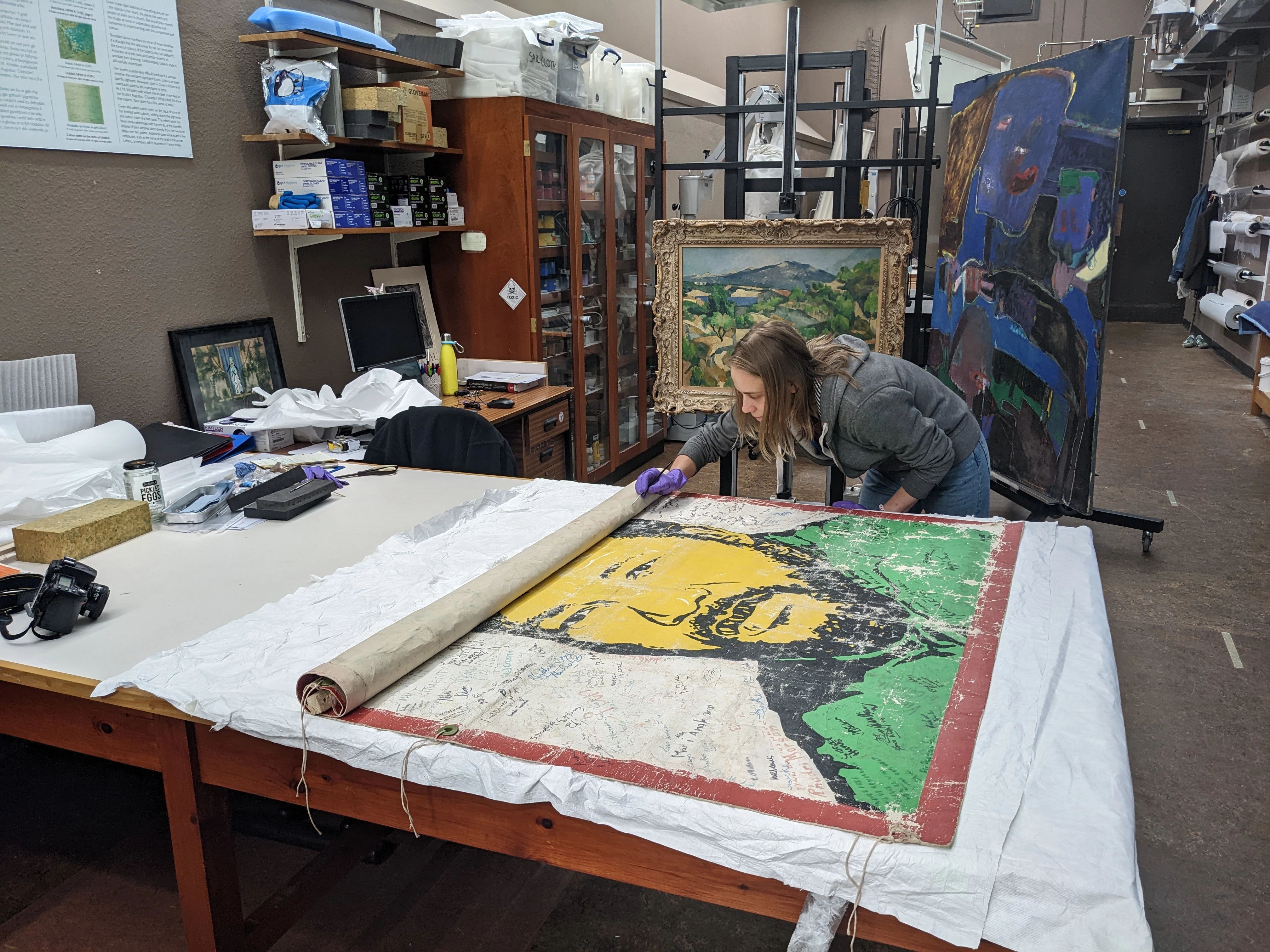 Putting back loose flakes of paint while unrolling the banner  