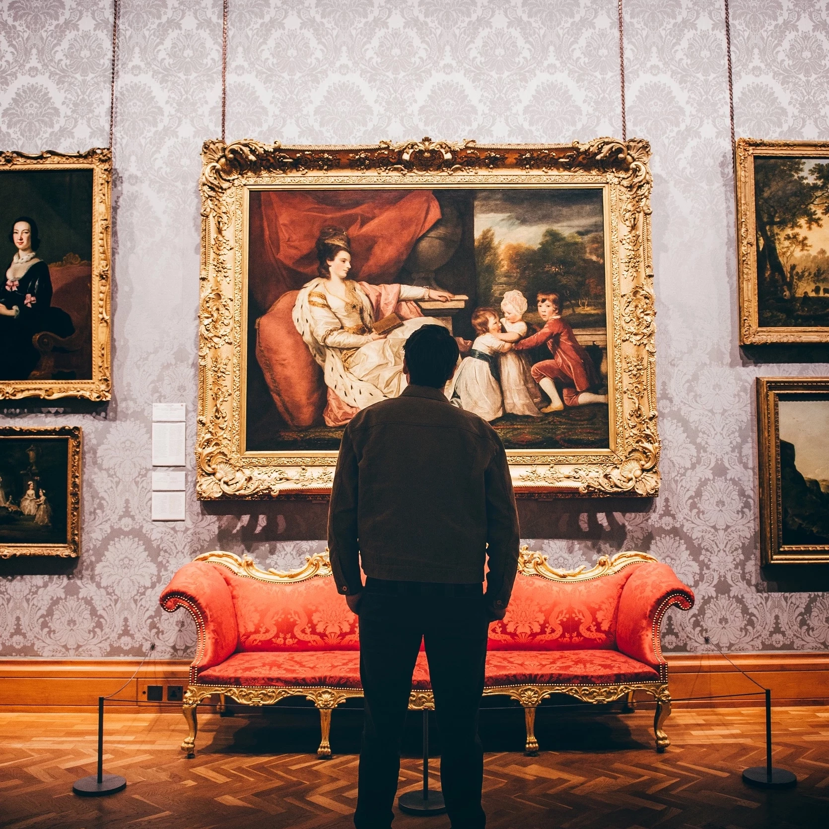 A person looking at a grand eighteenth century portrait in National Museum Cardiff