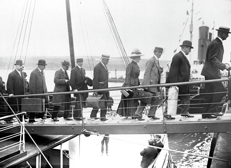 People walking onto a ship