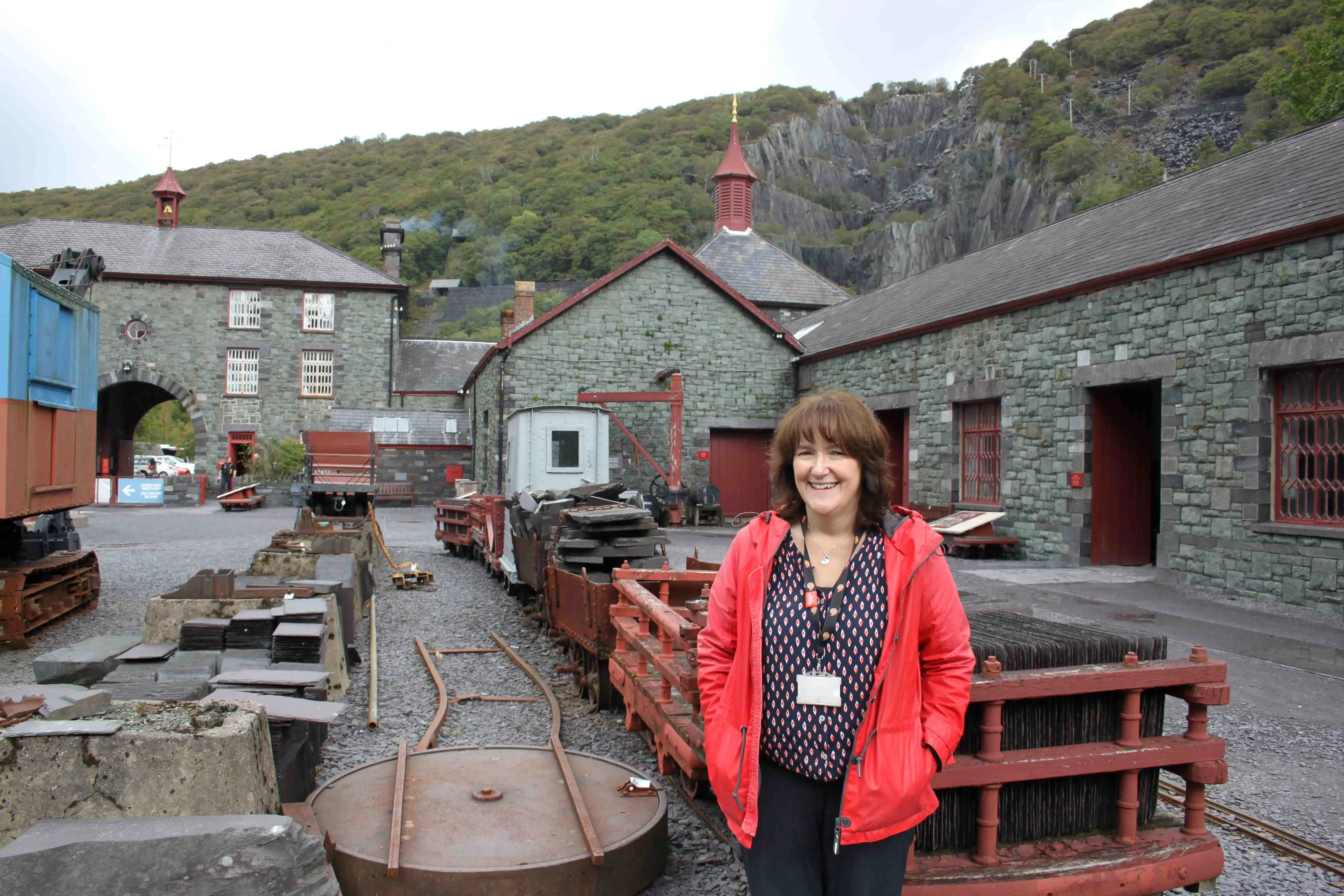 A woman in a red coat in the middle of the National Slate Museum 