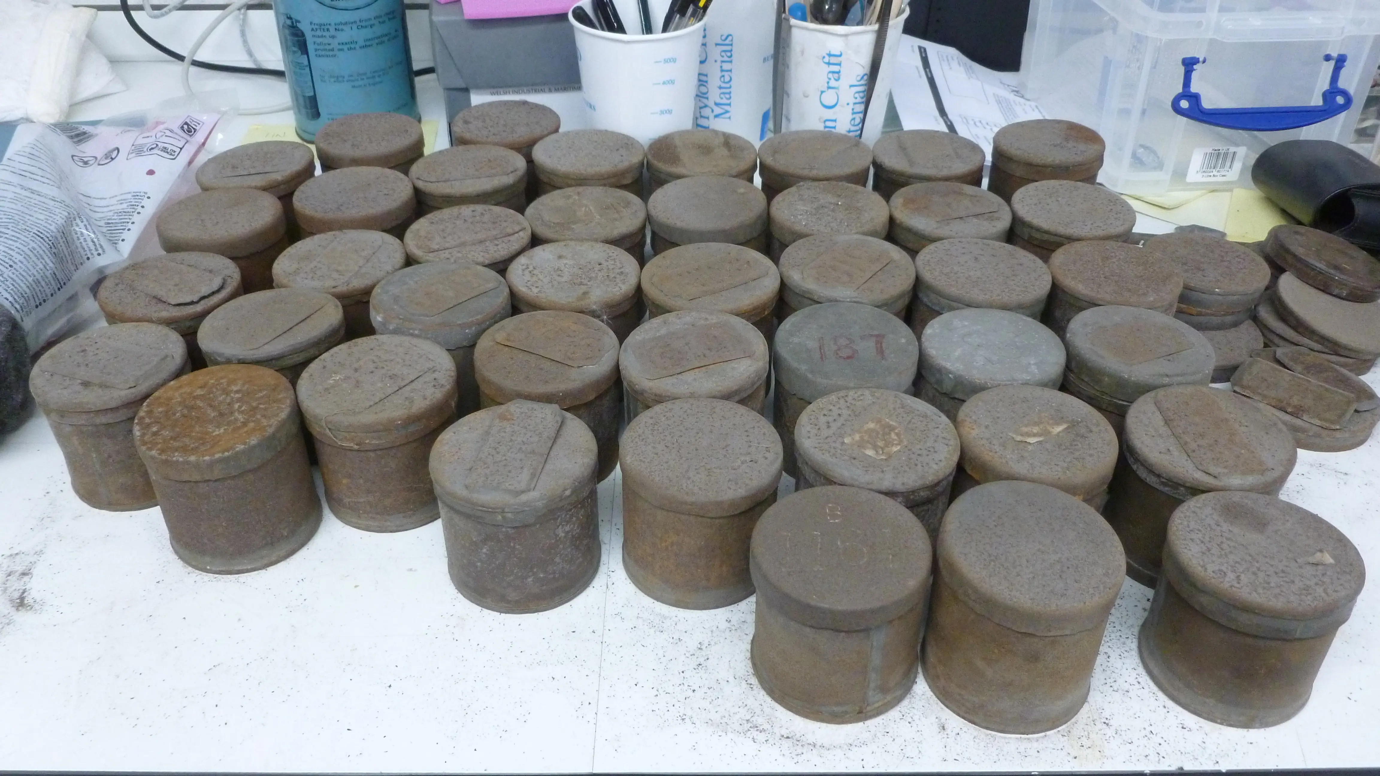 A collection of small metal pay tins