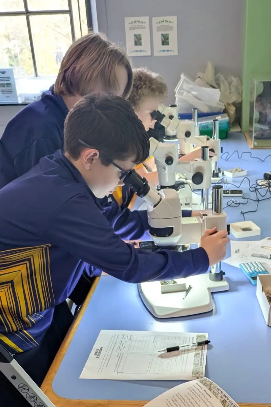 Pupils from Stanwell School Astronomy Club using microscopes to examine rocks