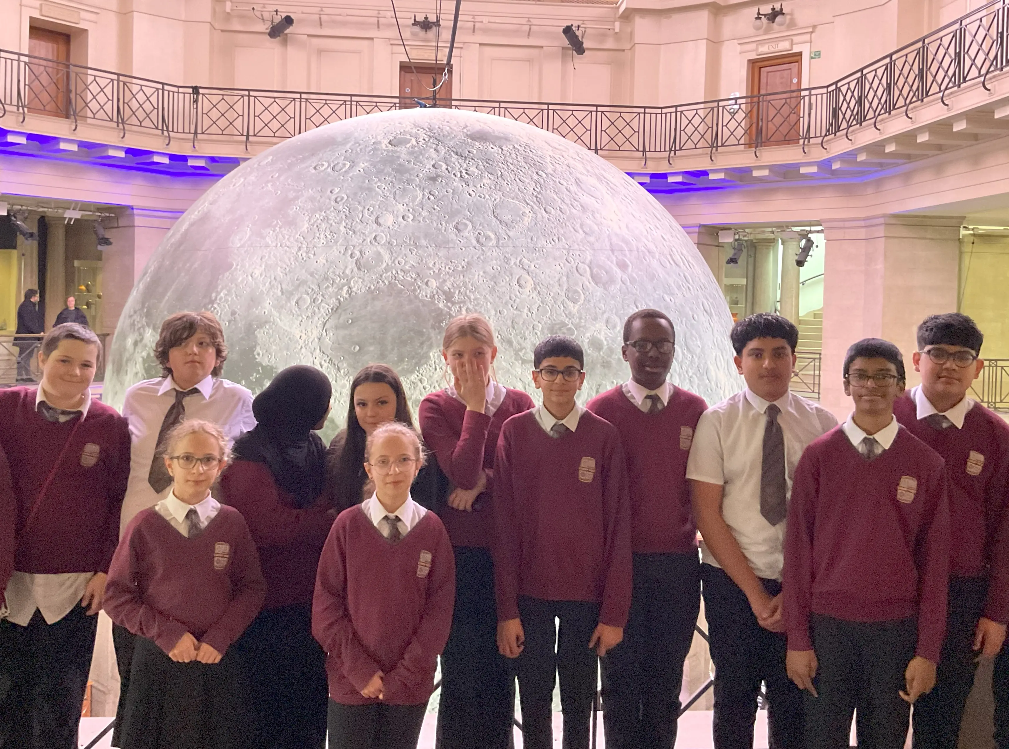 Pupils from Cardiff West Community High School with the Museum of the Moon sculpture