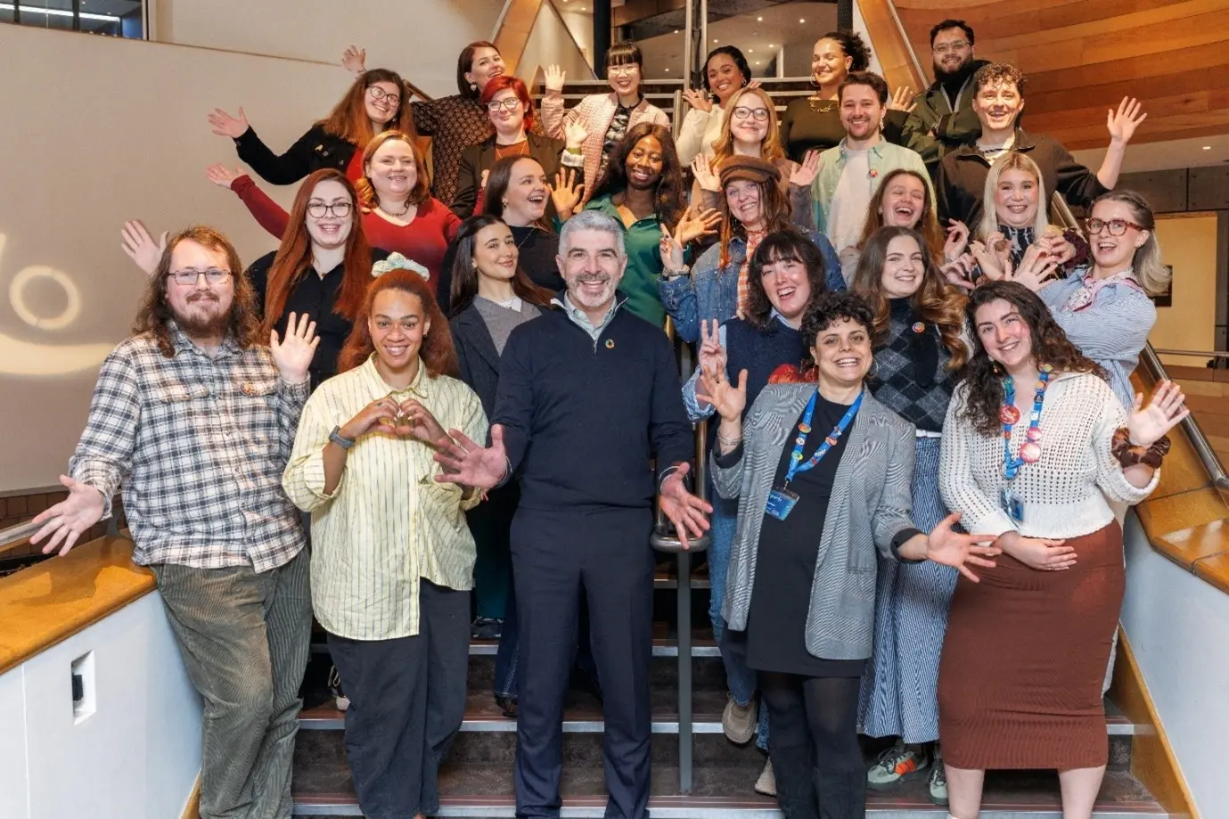 FGLA 5.0 Graduation in Wales Millenium Centre. The cohort and FGLA staff are waving at the camera.