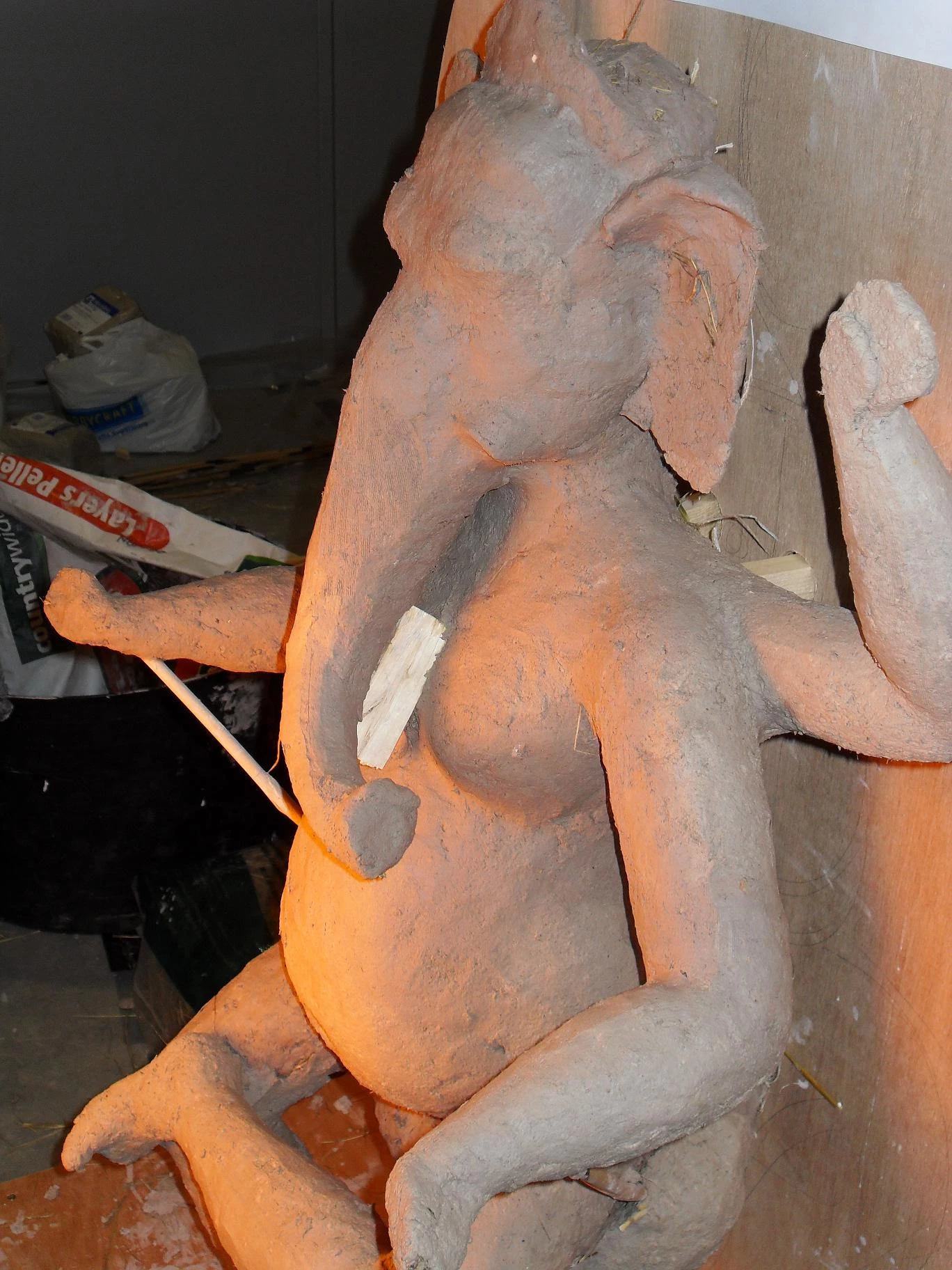 Using a heat lamp to dry the clay