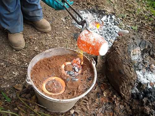 Pouring molten bronze.