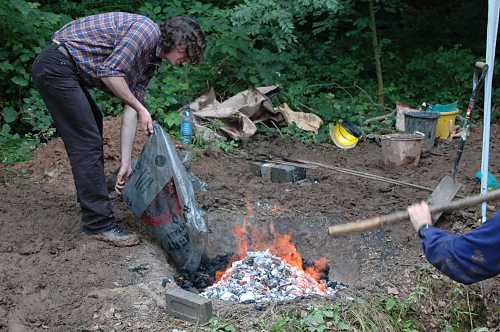 Adding charcoal to the furnace