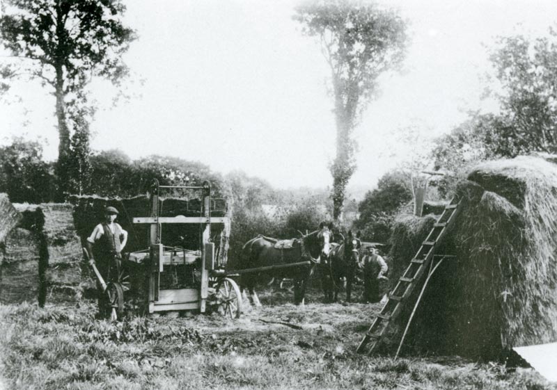 A hay press (an early form of baler) in use