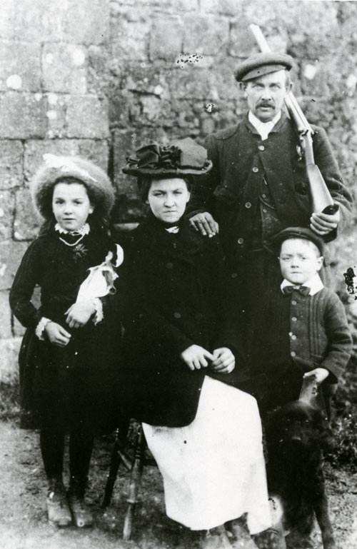 An unidentified gamekeeper with his family